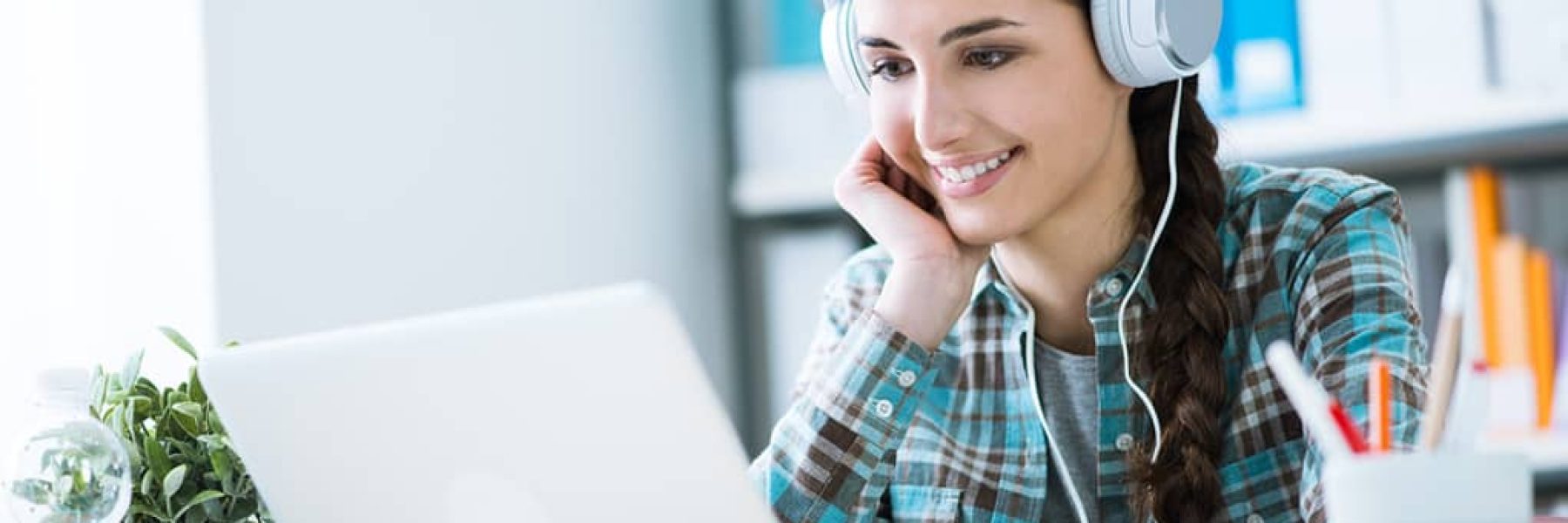 Girl-with-Headphones-Using-Laptop-Listening-to-Podcast-Feature-Image